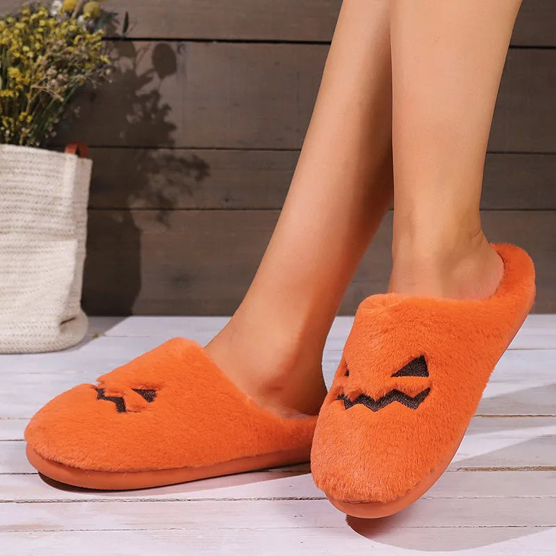 Orange Halloween pumpkin slippers with coral velvet upper and plush lining on non-slip PVC soles