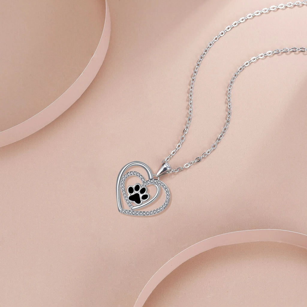 Women's dog paw print pendant necklace with electroplated copper finish on a cross chain.