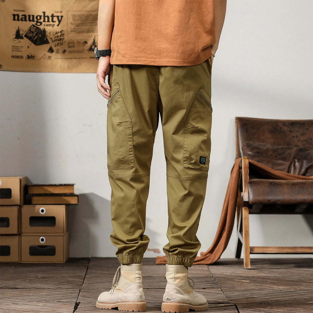 Men's loose khaki cotton harem trousers with tapered leg and ankle banding.