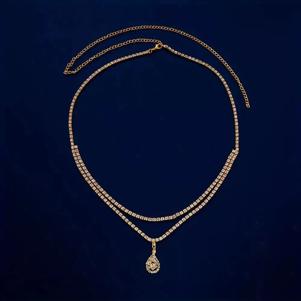 Gold or silver waist chain with water drop pendant and tassel elements, 115cm length with lobster clasp closure