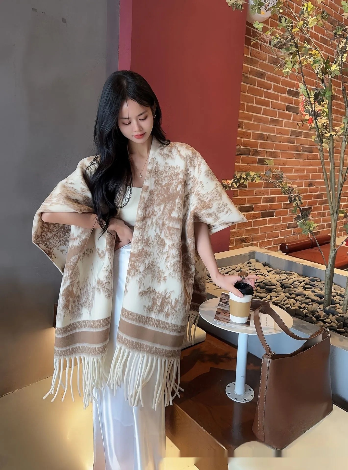 Women's polyester scarf cape with long fringed tassels, shown in a selection of available colours.