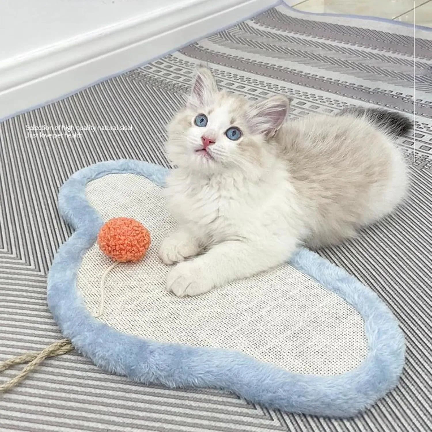 White wall-mounted cat scratching mat with cartoon sleeping cat design made from natural sisal.