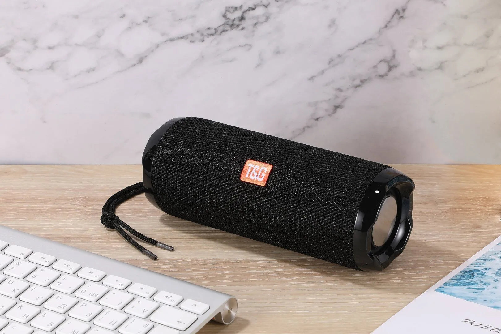 Fabric-covered portable Bluetooth speaker in multiple colours showing card holder slot.