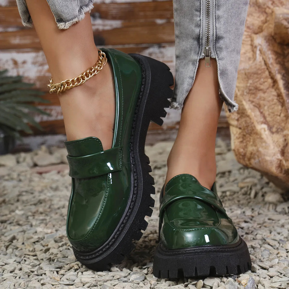 Women's black slip-on loafers with a chunky block heel and platform sole, shown from the side.