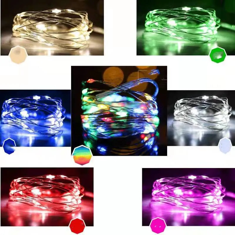 Copper wire LED string lights shaped around a bottle, showing multiple small coloured bulbs.