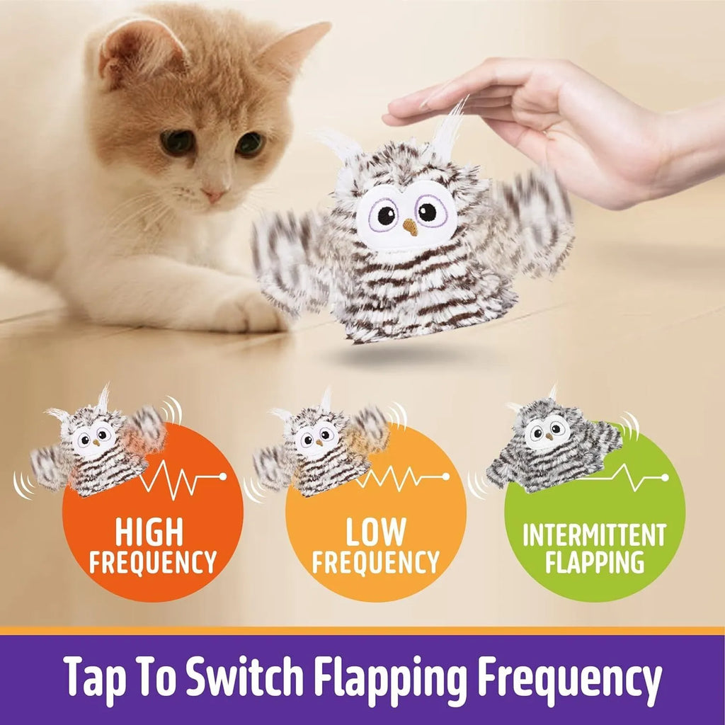 Grey automatic chirping owl cat toy with beating wings on a floor.