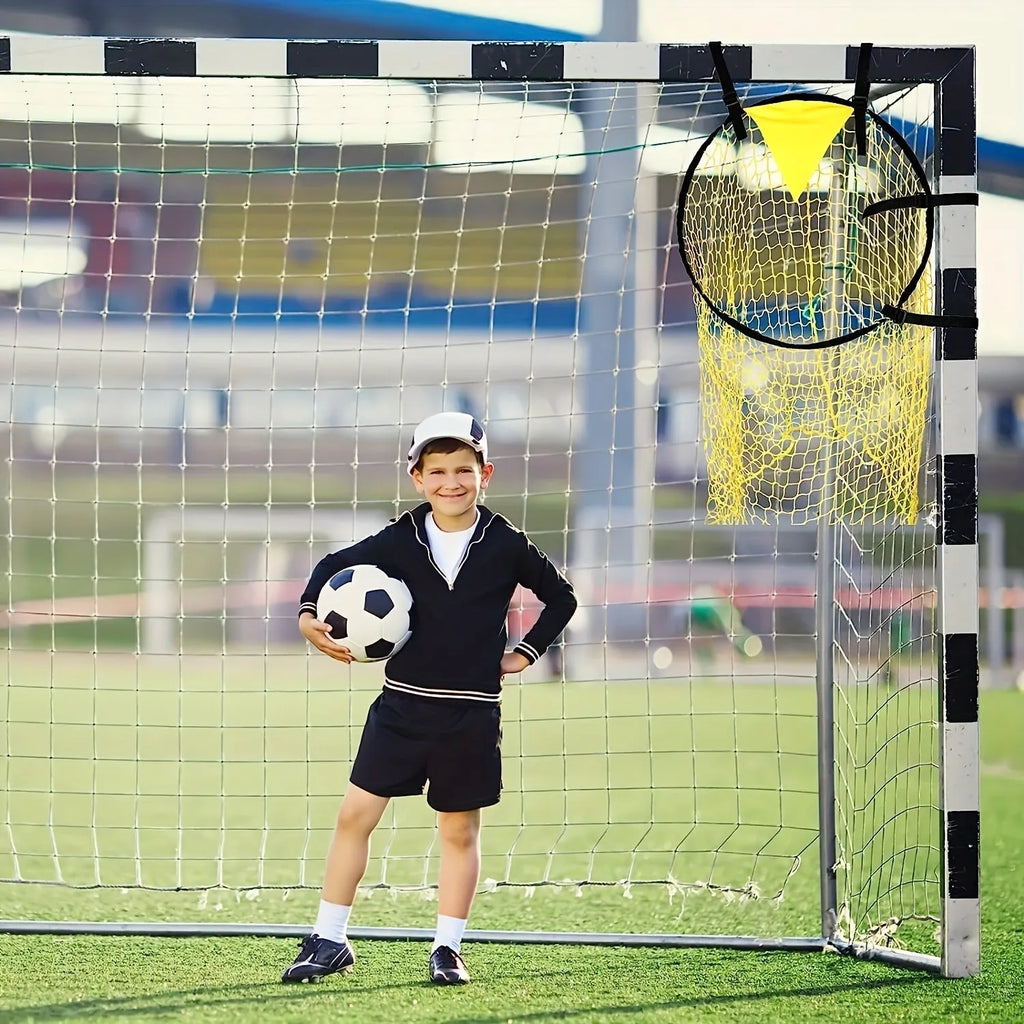 Portable black and yellow soccer training goal net set up on a grass field.