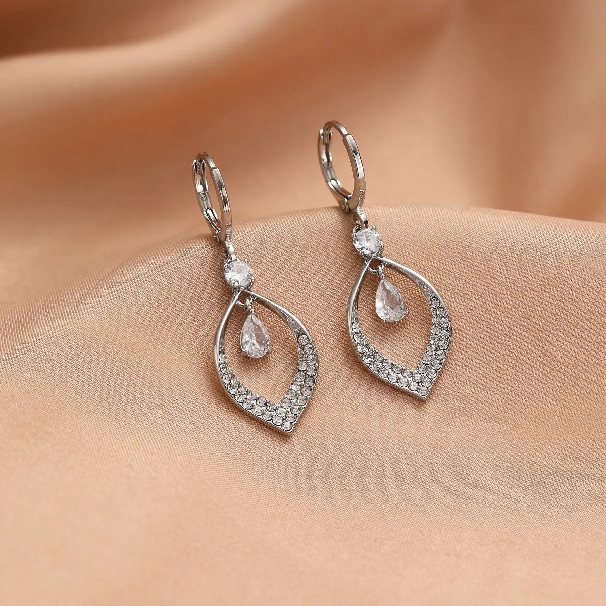 Gold and silver coloured zircon water drop tassel earrings with a tear-drop shape.