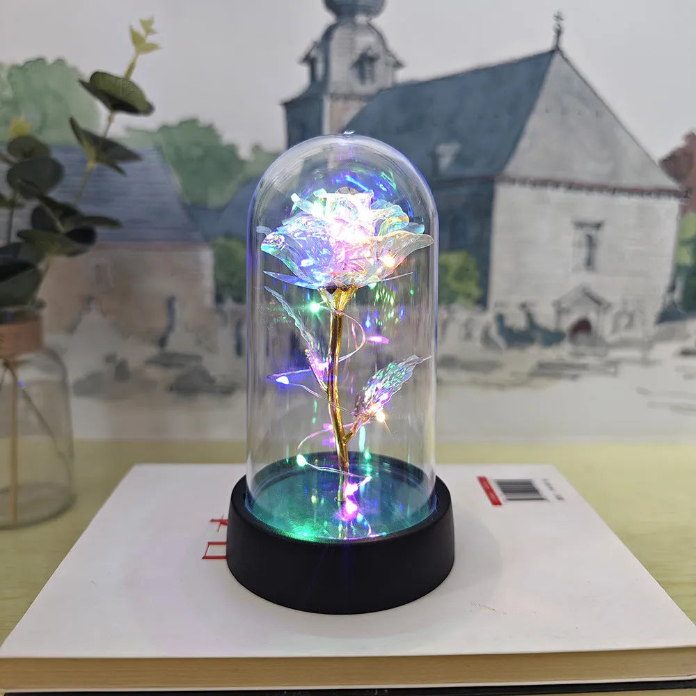 Small plastic night lamp with glass cover and flower decoration on black base