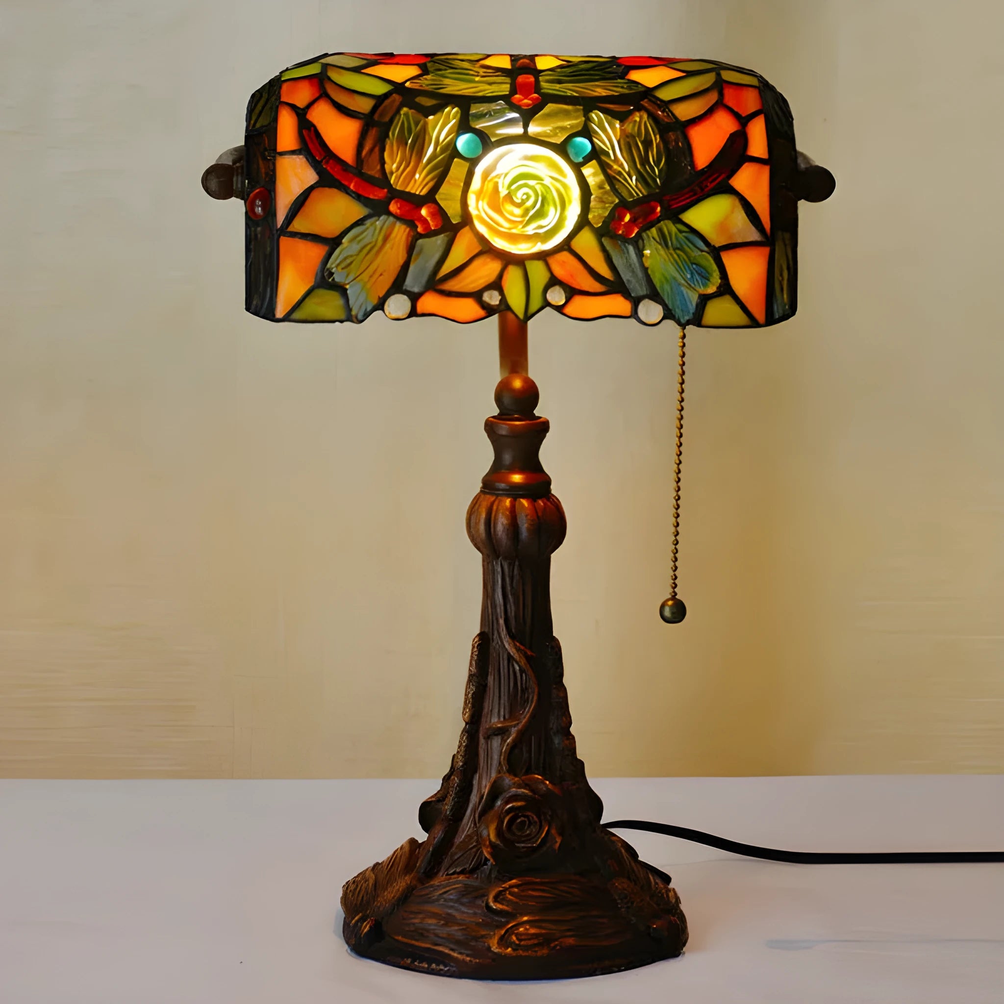 10-inch Tiffany table lamp with coloured stained glass shade and resin base on desk
