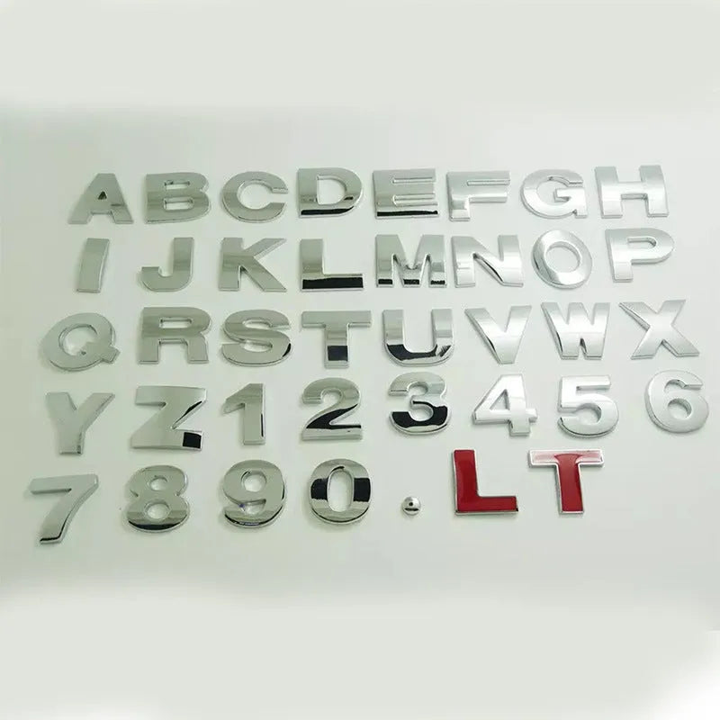 Close-up of a silver zinc alloy 3D raised letter 'A' car bumper sticker, approx 2.5cm tall.