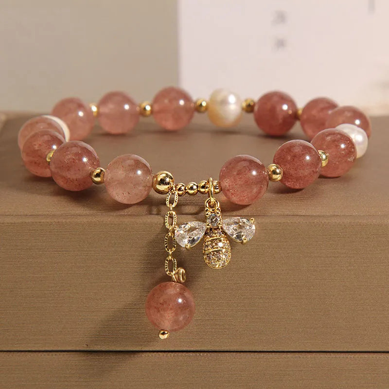 Women's strawberry quartz and freshwater pearl bracelet with zircon bee charm in Japanese-Korean jewellery style