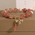 Women's strawberry quartz and freshwater pearl bracelet with zircon bee charm in Japanese-Korean jewellery style