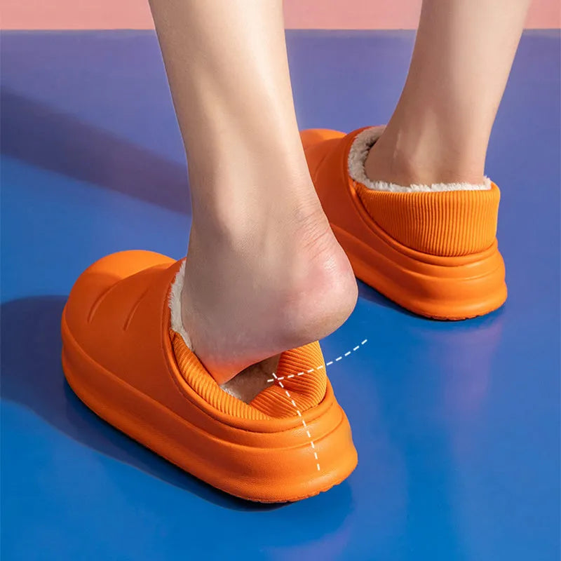Women's green waterproof EVA winter slippers with plush lining and a non-slip sole.