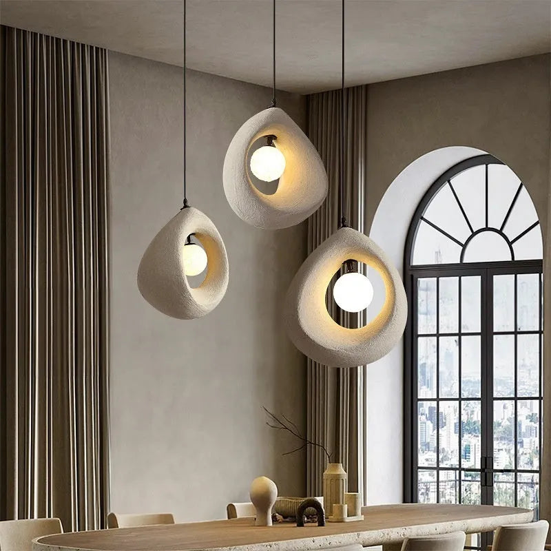 Sili Style modern pendant light with milky white glass shade in a dining room setting.
