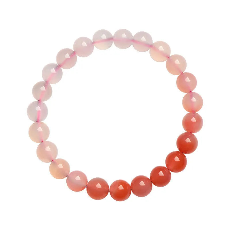 Natural gradient colour agate bracelet with geometric beads on a wrist.