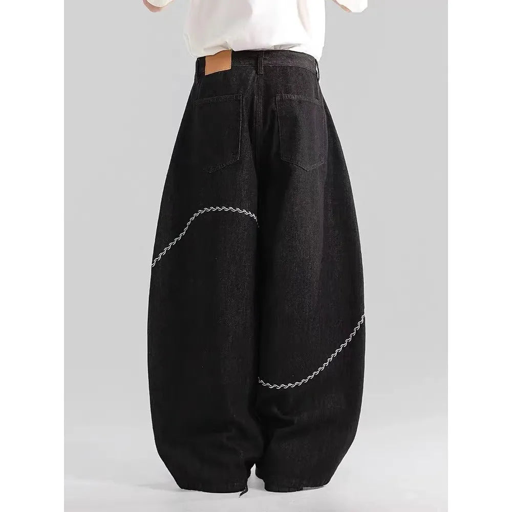 Black straight-leg denim trousers with a mid-waist and zip fly on a mannequin.