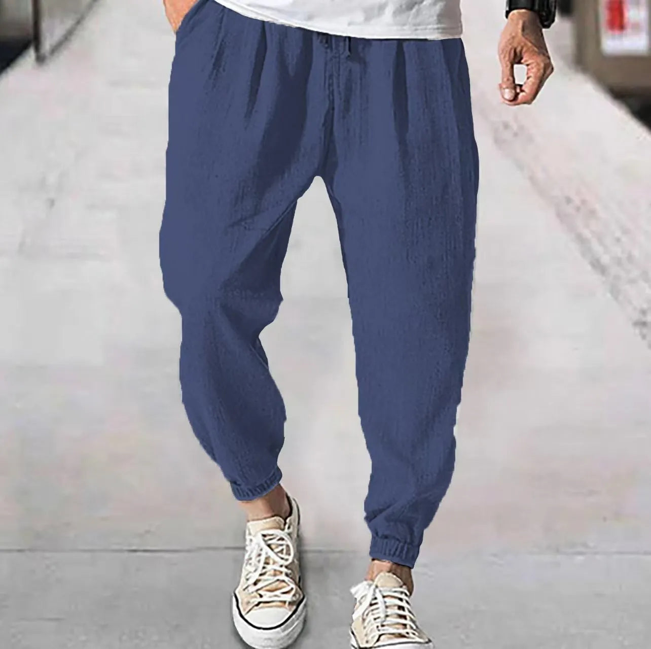 Men's loose casual cotton trousers with an elasticated ankle band in light green.
