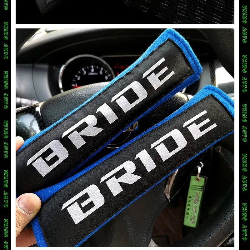 Pair of black car seat belt shoulder pads with embroidery, showing dimensions.