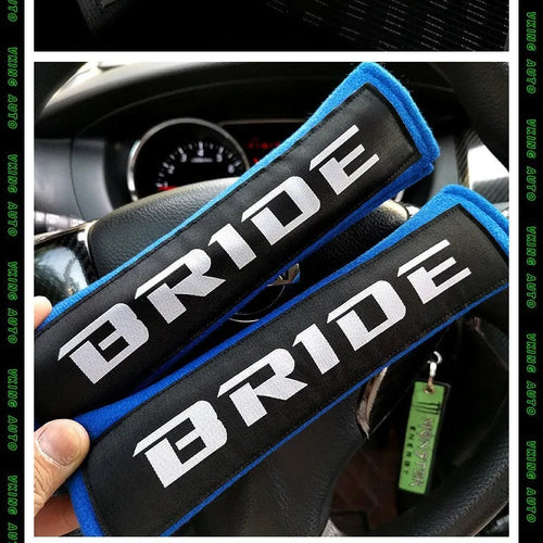 Pair of black car seat belt shoulder pads with embroidery, showing dimensions.