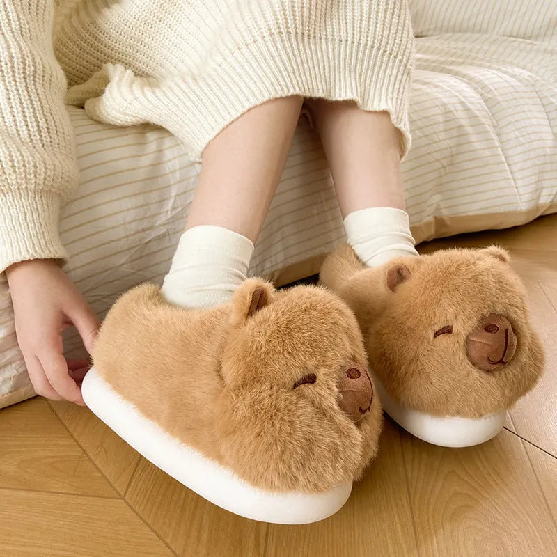 Light brown women's plush winter slippers with artificial wool lining and a PVC sole.