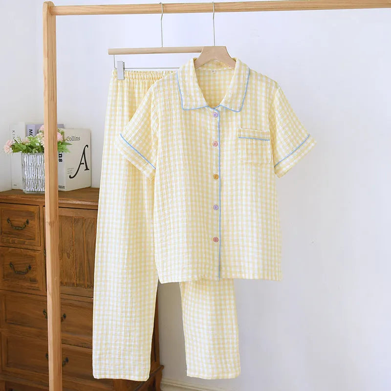 Women's loose-fit yellow plaid cotton gauze short-sleeve top and trouser set on a hanger.