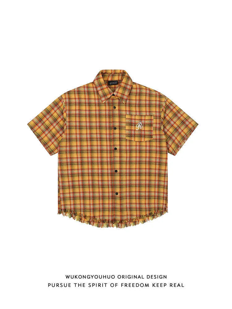 Yellow grid plaid short sleeve shirt with an embroidered chest pocket, shown in a loose unisex fit.