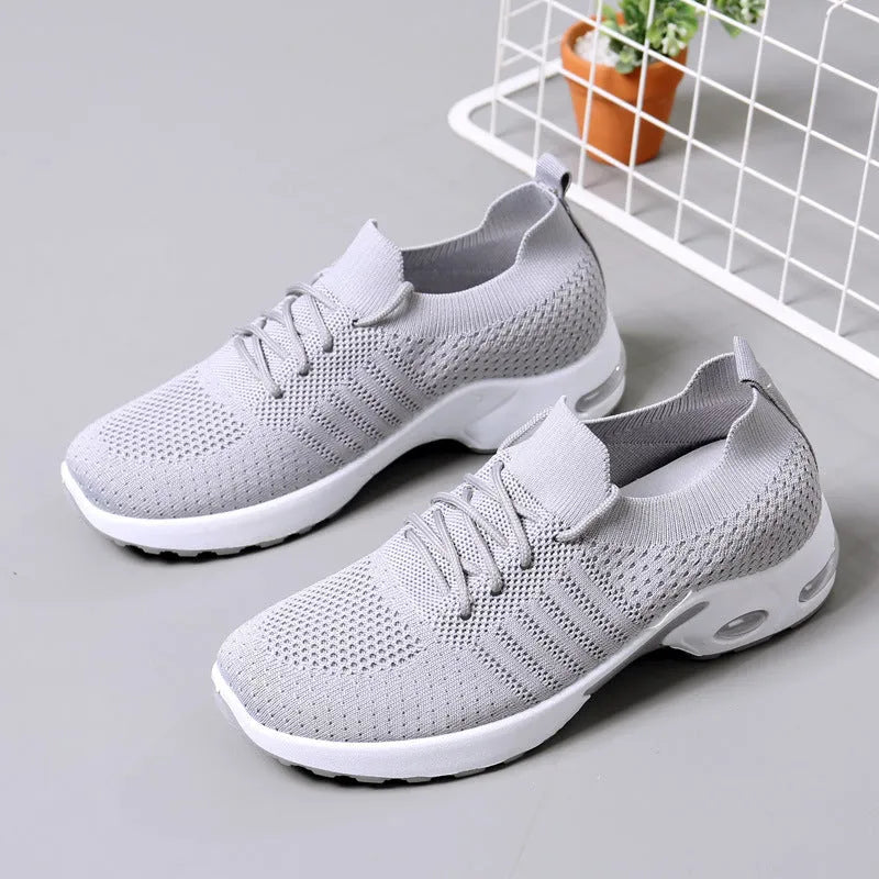 Women's black mesh casual sneakers with lace-up front and a light grey PVC sole.