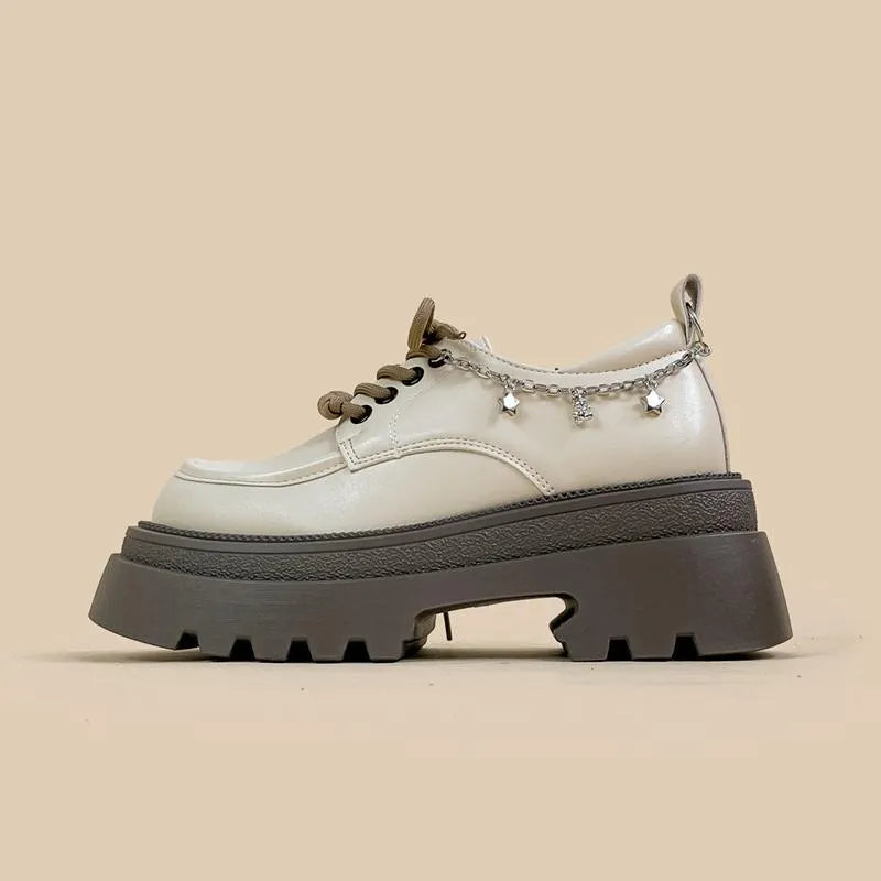 White platform Mary Jane shoes with chunky heel and round toe, front lace-up design
