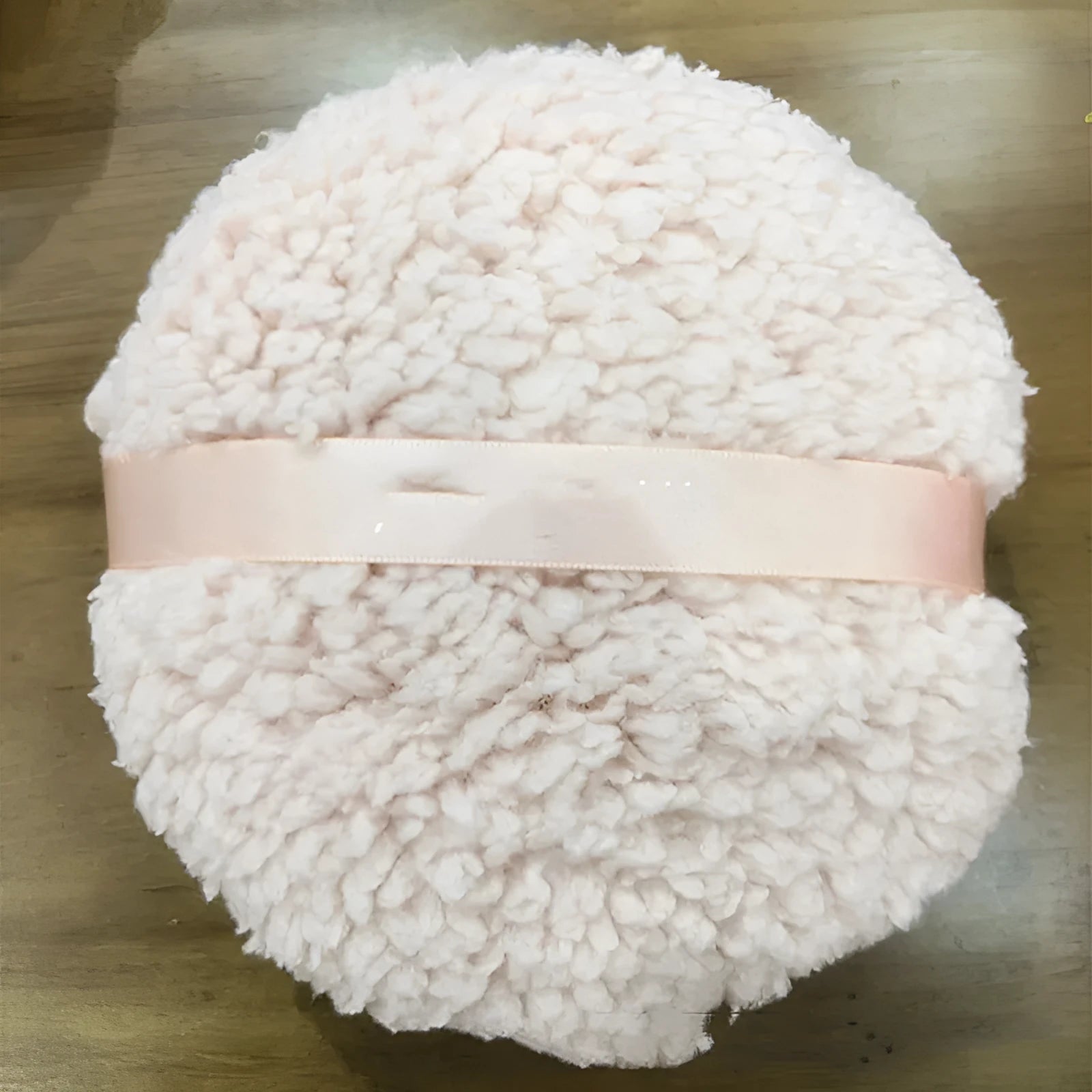 Oversized plush makeup powder puff in white, shown with dimensions 150mm by 75mm