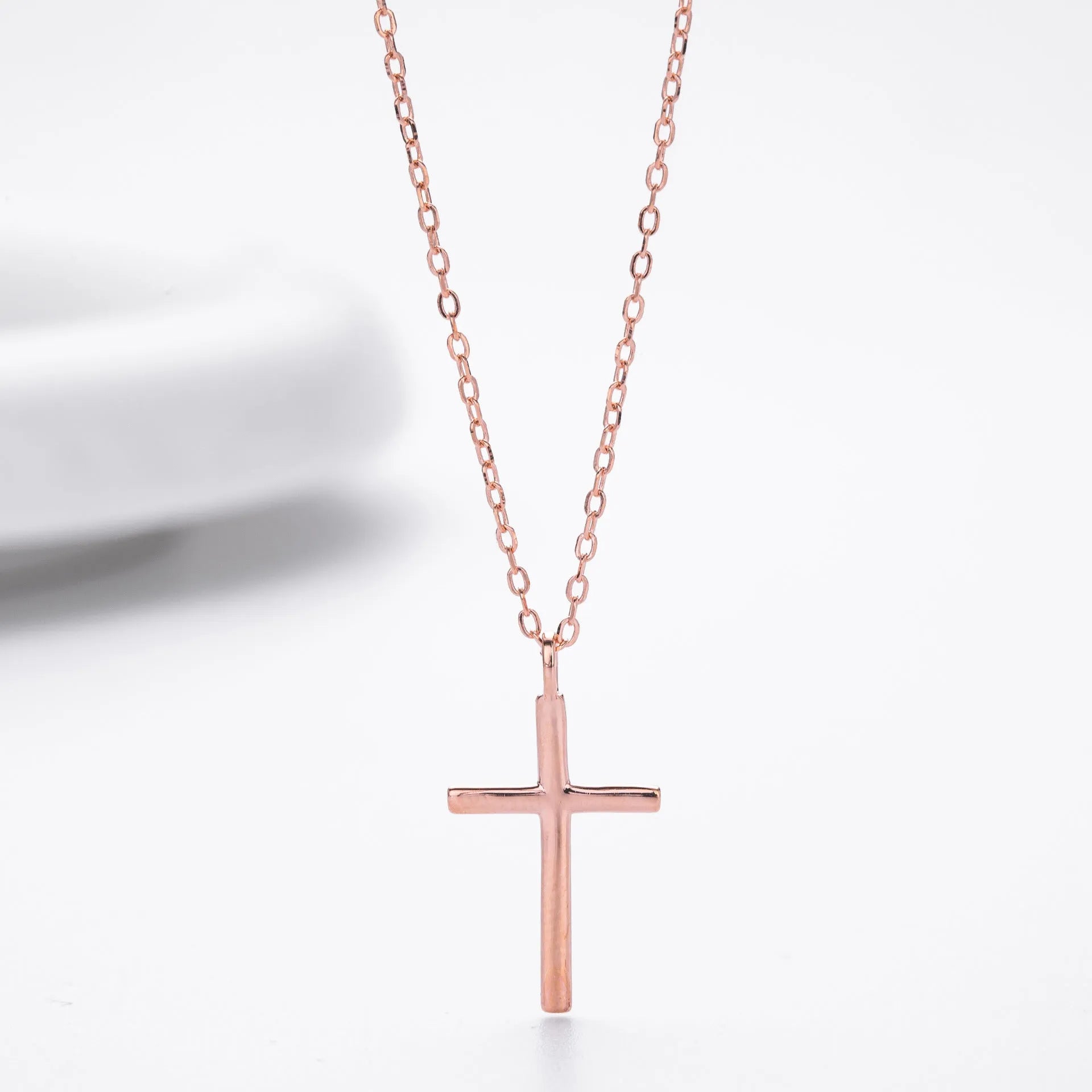 Sterling silver cross pendant necklace on an adjustable O-shaped chain, shown in gold plating.