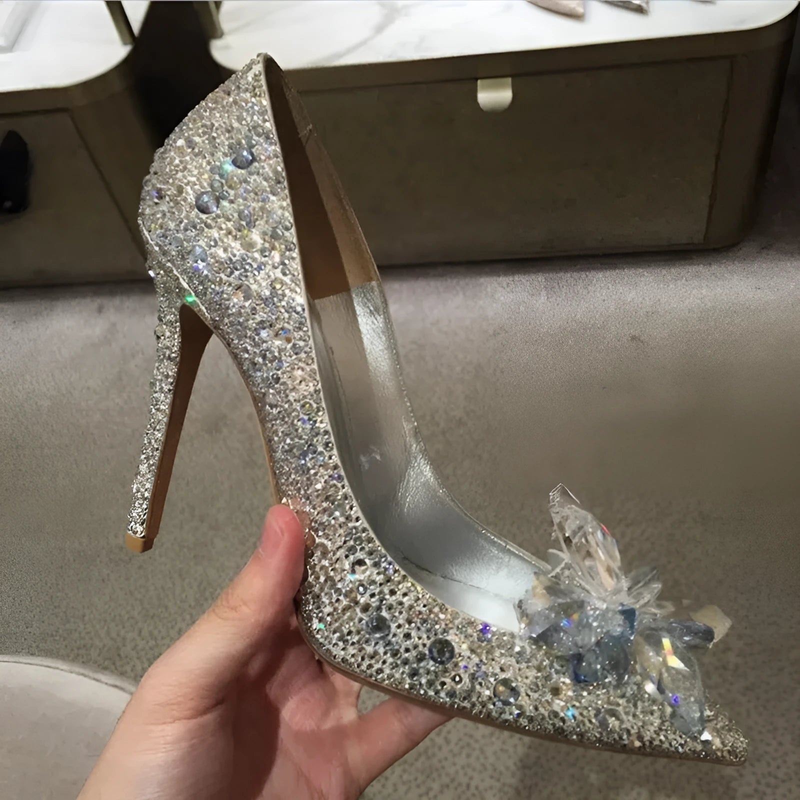 Gold women's pointed toe stiletto high heels with rhinestone and sequin decoration on a shallow-mouth, low-top upper.