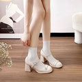 Women's black patent leather wide-fit chunky heel shoes with round toe and buckle fastening.