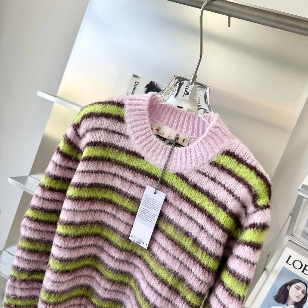 Pink women's wool knitted cardigan and round-neck pullover sweater with contrast details on a hanger.