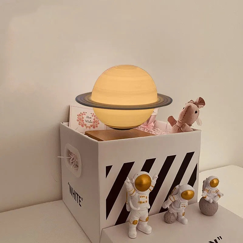 Maglev floating planet night light with LED glow, astronaut figurines, and USB cable.