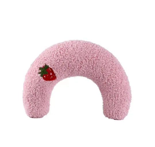 Small white U-shaped plush pet pillow for cats and small dogs on a neutral background.