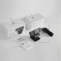 Black USB webcam with attached cable and a magnetic privacy cover on a desk.