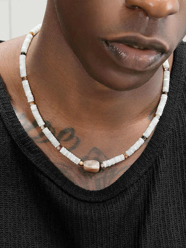 Men's vintage white shell necklace with round bead chain on neutral background