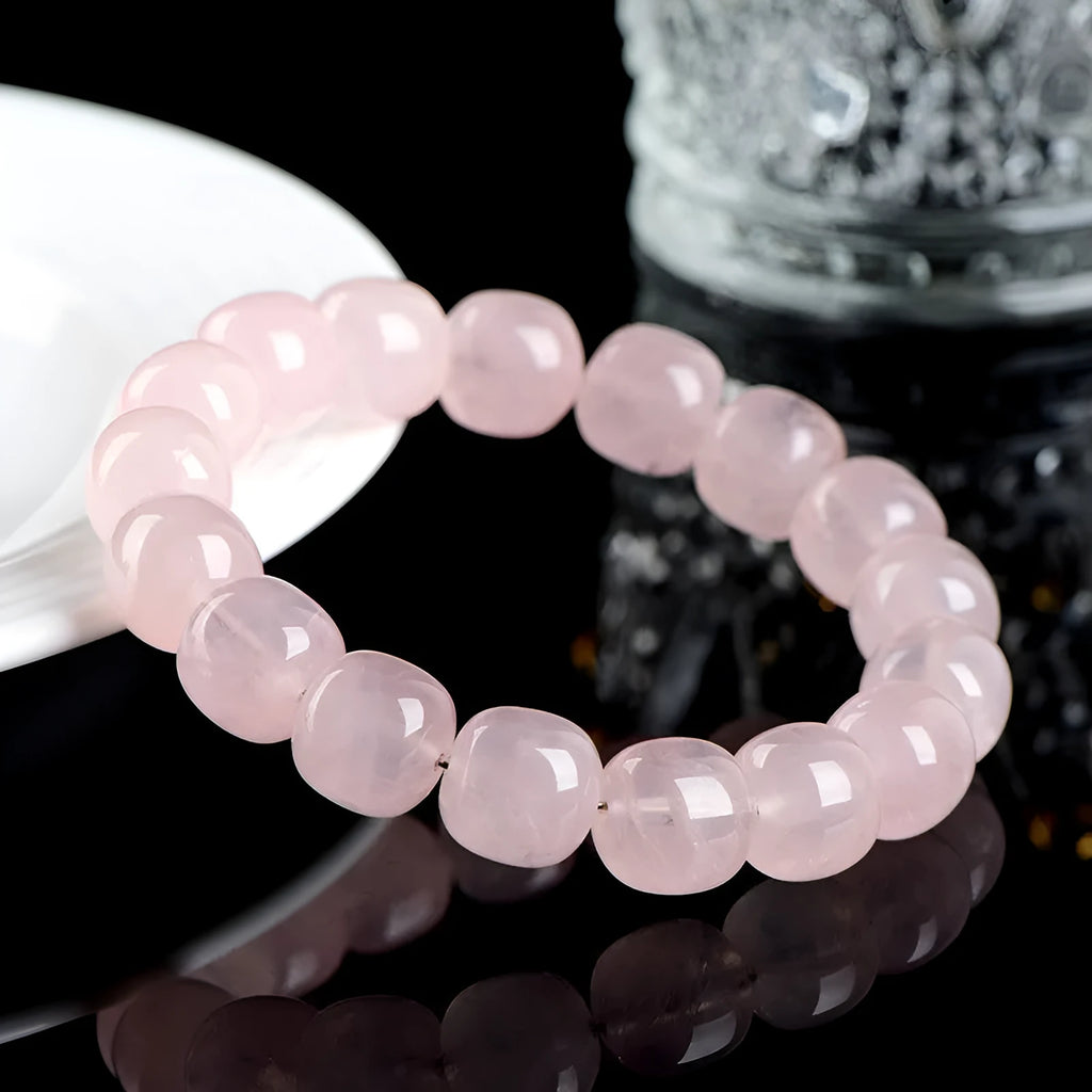Pink crystal barrel bead bracelet with geometric design for men and women.