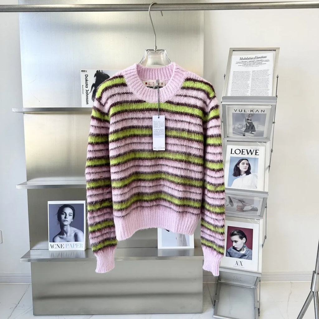 Pink women's wool knitted cardigan and round-neck pullover sweater with contrast details on a hanger.