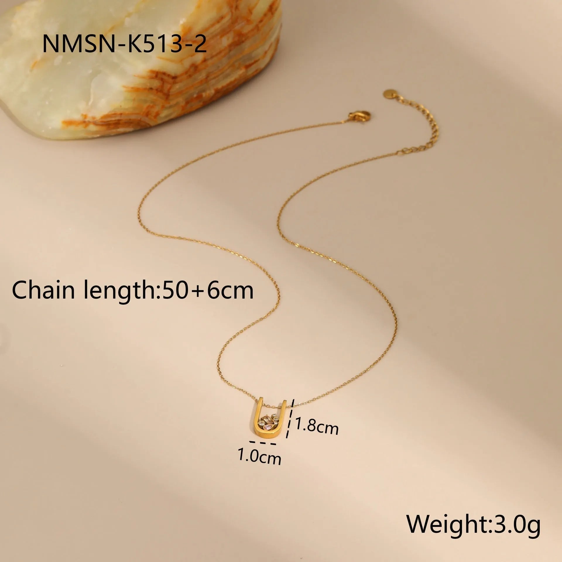 Geometric gold plated jewellery set showing necklace, ring, and earrings with chain-style design