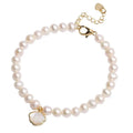 Freshwater pearl bracelet with fan-shaped shell setting and elastic string or extension chain fastening.