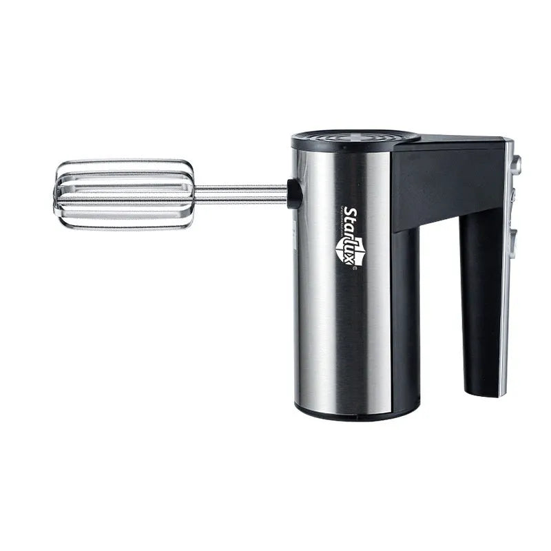 White handheld electric mixer with a stainless steel whisk attachment on a kitchen counter