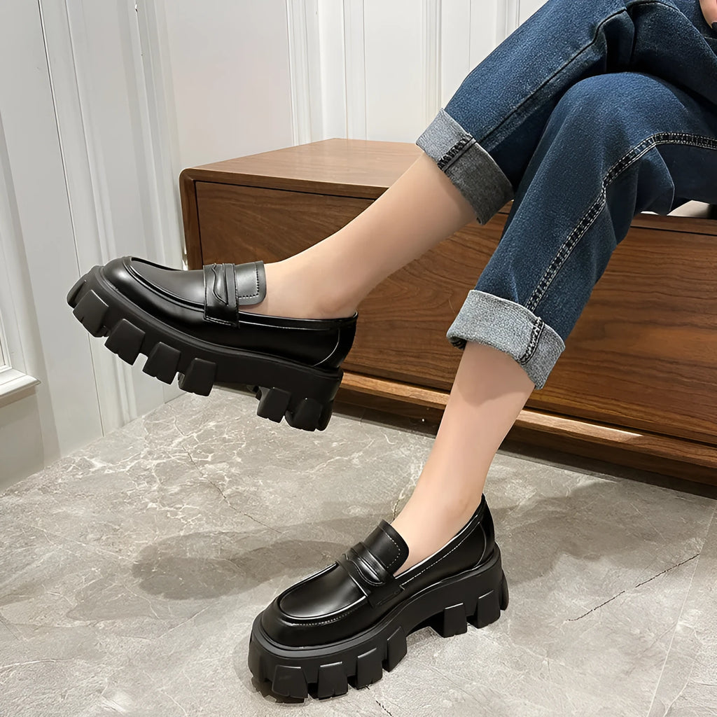 A pair of wide fit leather loafers in a slip-on style with a rubber sole, shown in a choice of finishes.
