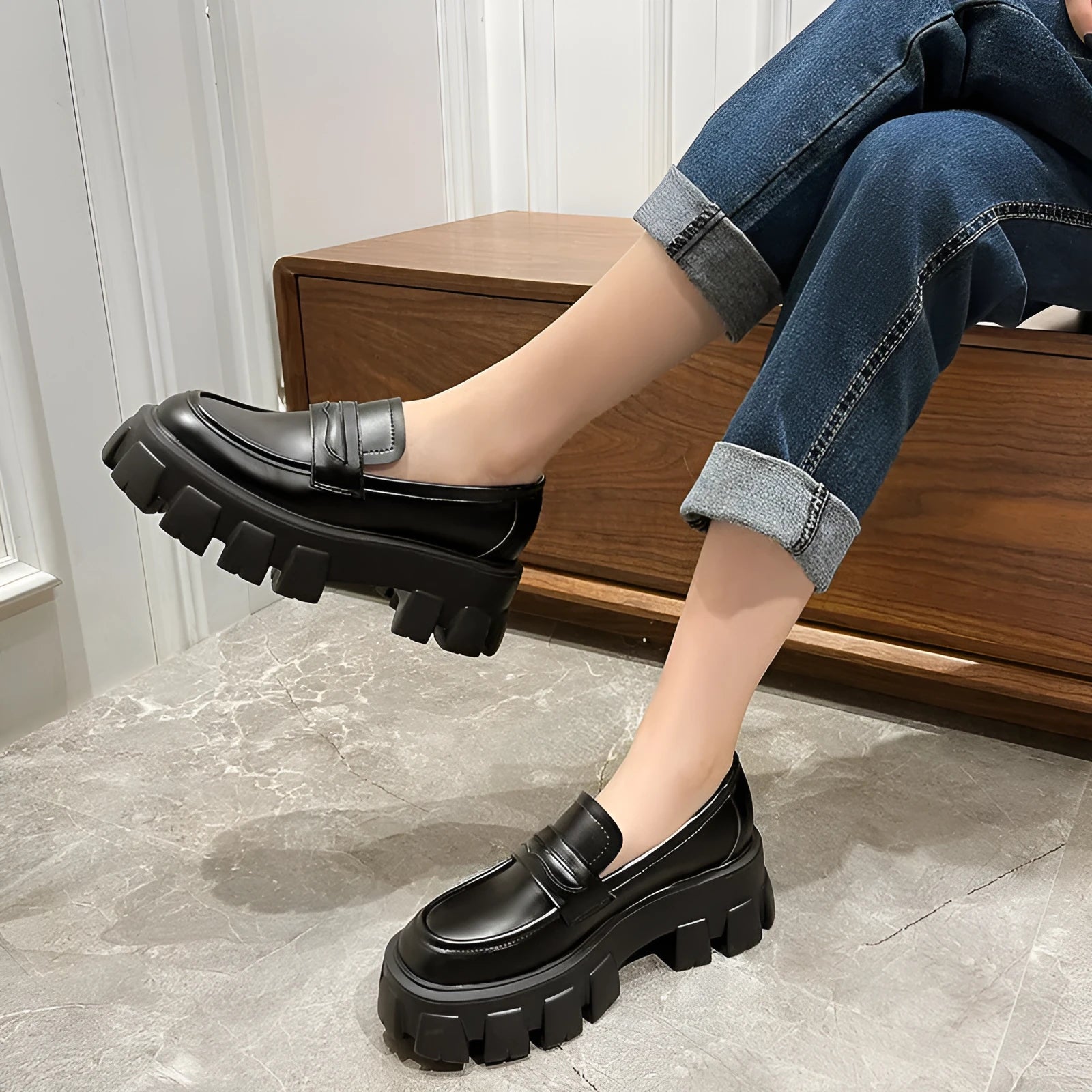 A pair of wide fit leather loafers in a slip-on style with a rubber sole, shown in a choice of finishes.