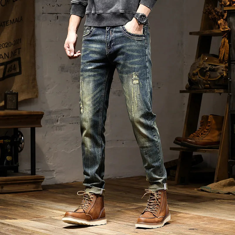 Men's skinny fit stretch denim jeans in a retro colour with a zip fly, laid flat.