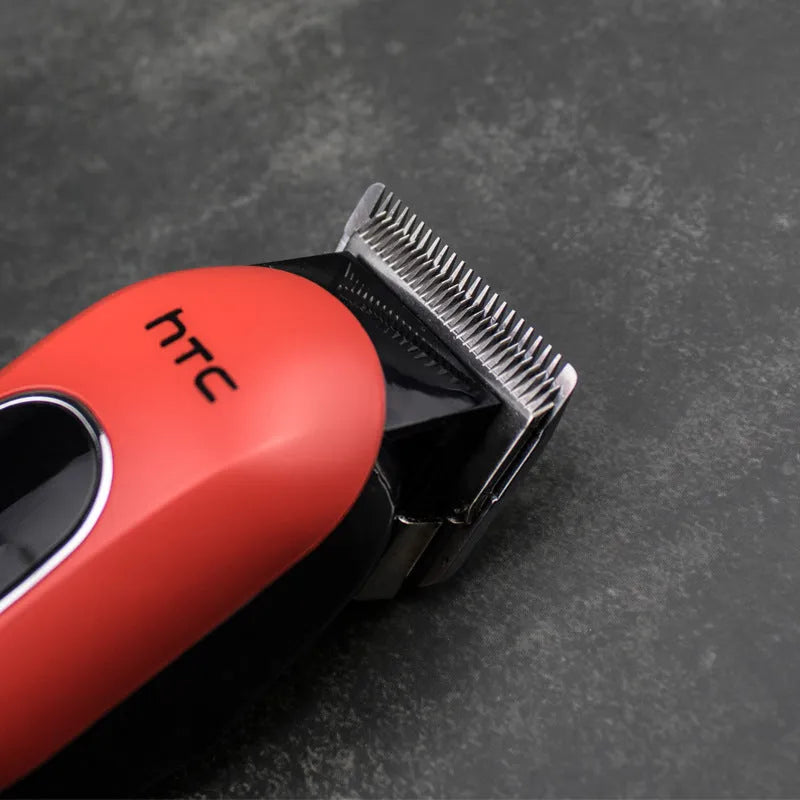 Professional rechargeable hair clipper in black, red, or white with four attachment combs and cleaning accessories.