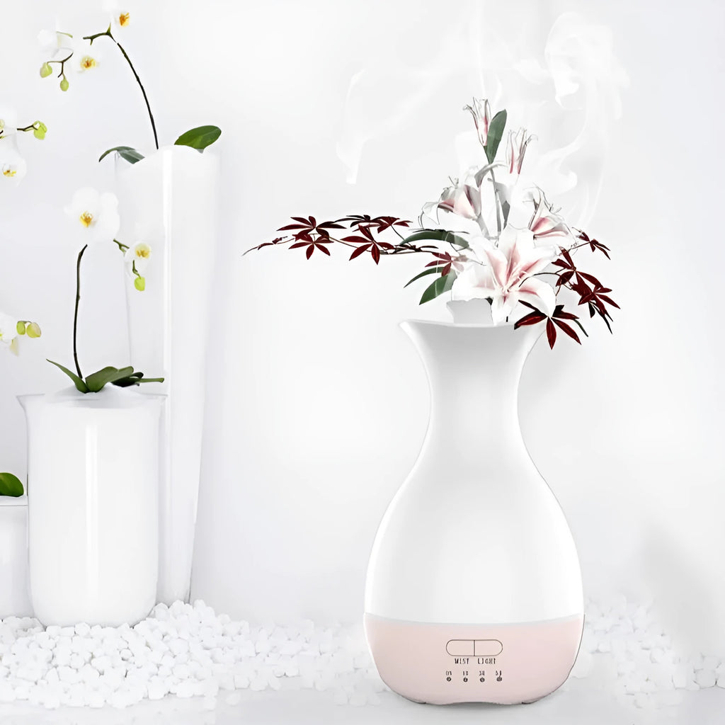 White ultrasonic aromatherapy diffuser and humidifier with colourful LED light misting on a wooden table.