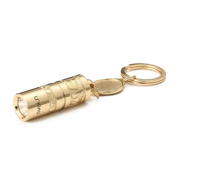 Gold-coloured zinc alloy waterproof mini LED flashlight on a keychain.