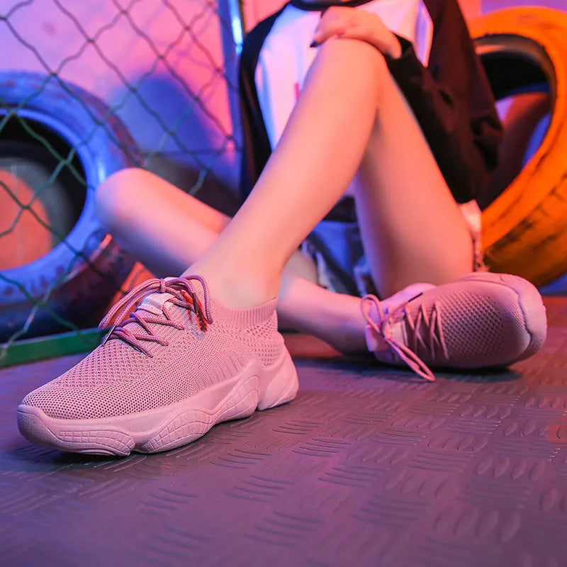 White women's thick-soled flying woven sports shoes with a front strap and rubber sole.
